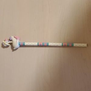 Wooden Pencil topped with a Goose wearing a Straw Hat and holding a Purple Egg